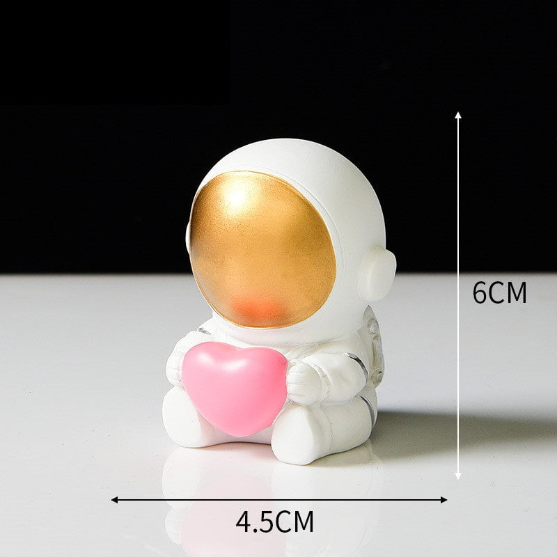 The style K Ornament is an astronaut wearing a golden visor holding a love heart in his arms.