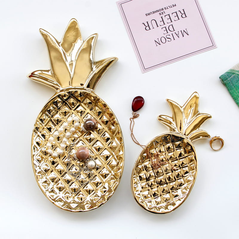 Big pineapple and small pineapple shaped ceramic jewelry trays.