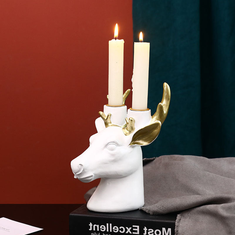 Display for white deer head resin candle holder.