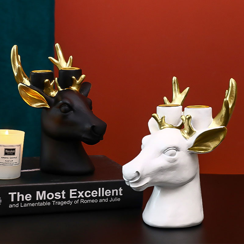 Display for black and white deer head resin candle holder.