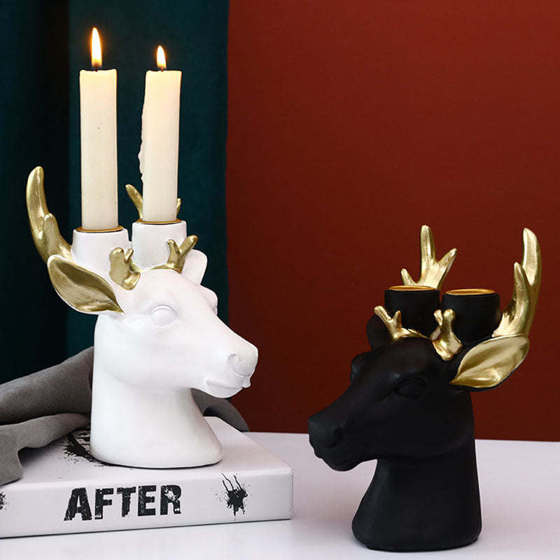 Display for black and white deer head resin candle holder.