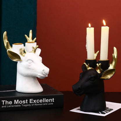 Display for black and white deer head resin candle holder.