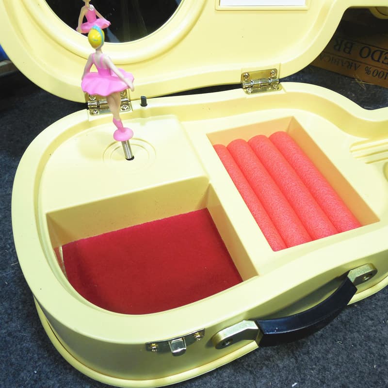 Close-up of interior for yellow lovely violin musical jewelry box for girl.