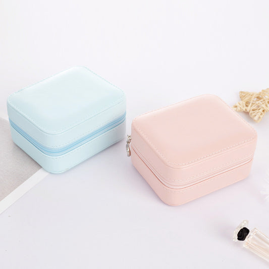 Exterior for pink and blue mini portable jewelry boxes with zipper closure.