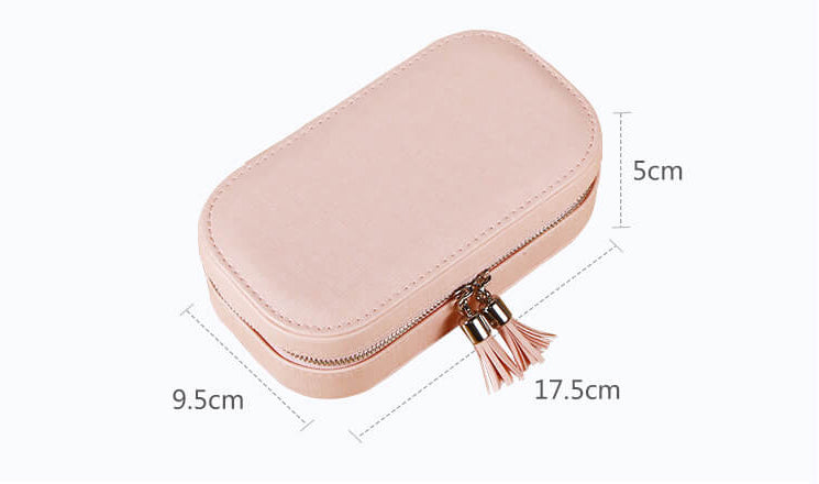 Exterior and size for pink portable jewelry box designed with tassels and zipper closure.