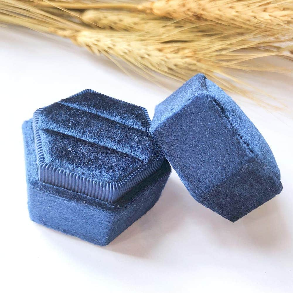 Blue fine hexagon velvet ring box with double slot.