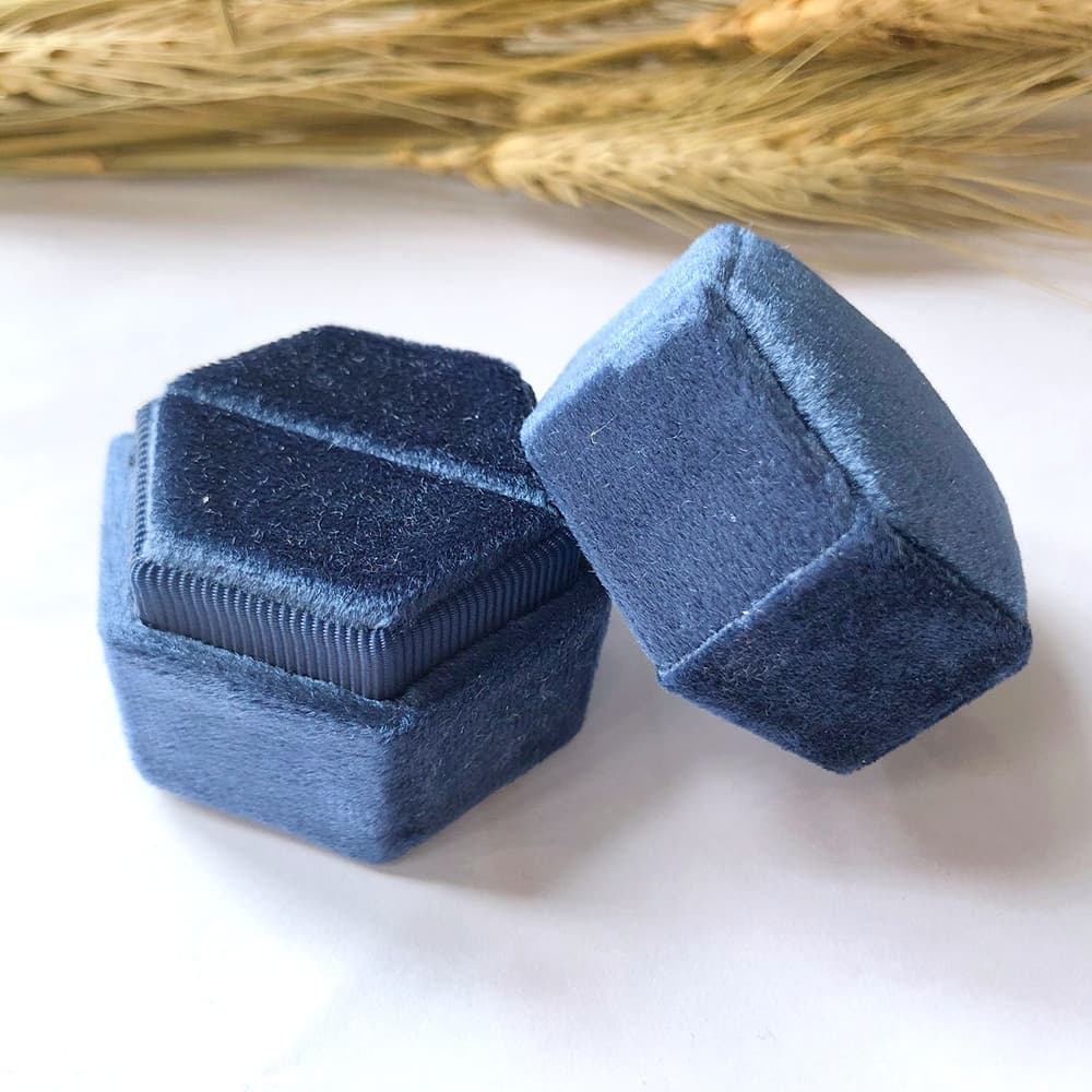 Blue fine hexagon velvet ring box with single slot.