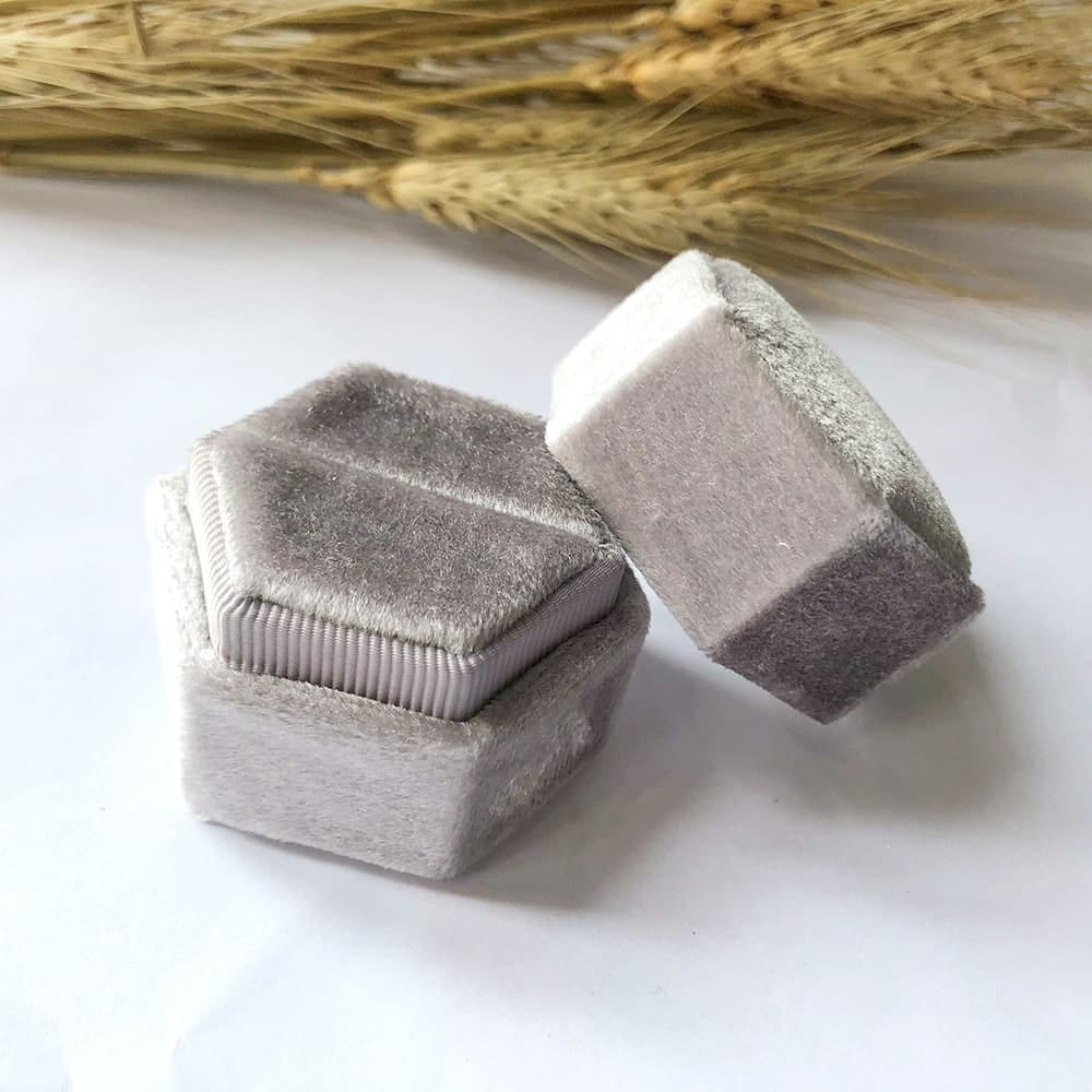 Grey fine hexagon velvet ring box with single slot.