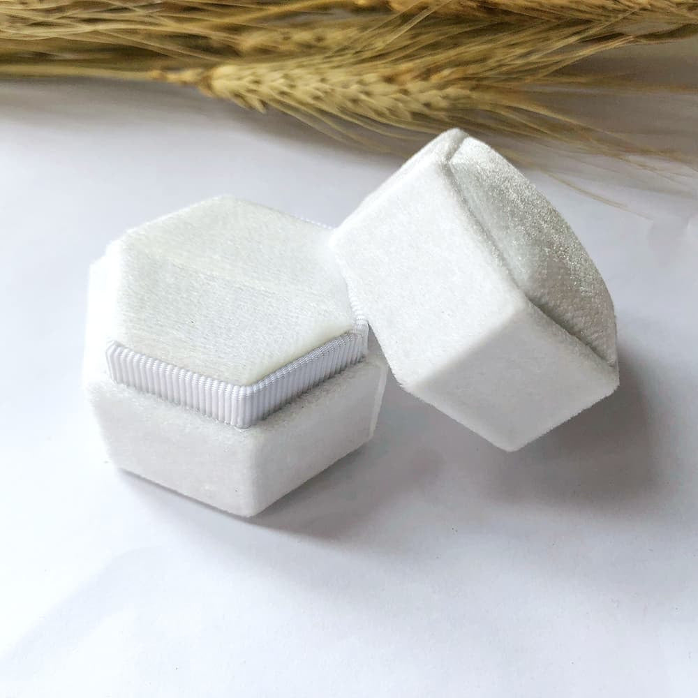 White fine hexagon velvet ring box with single slot.