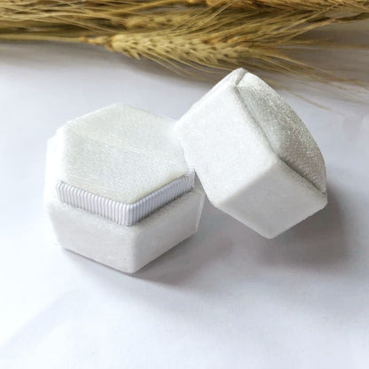 White fine hexagon velvet ring box with single slot.