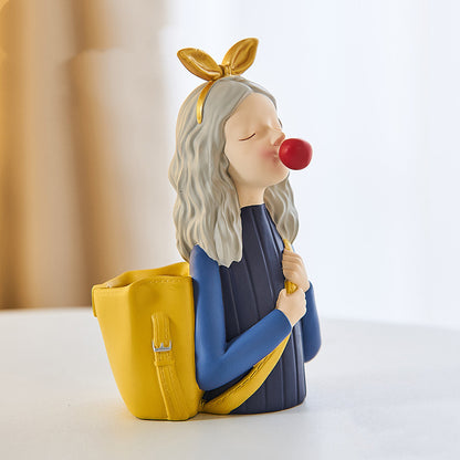 Display for yellow girl with a backpack resin pen holder.