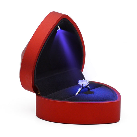 Interior for red heart-shaped ring box with light.
