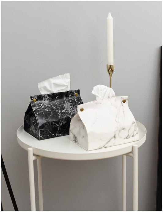 Display for black and white marbled leather tissue box.