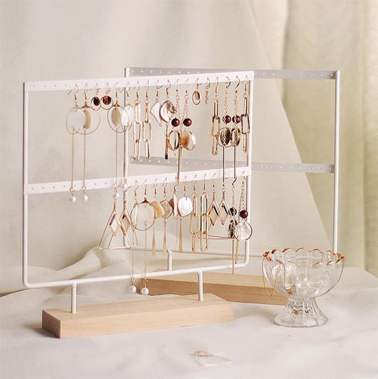 White metal jewelry stand tower with wooden base for earring and bracelet.