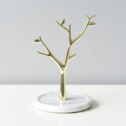 Gold metal tree-shaped jewelry stand tower with white marble base.