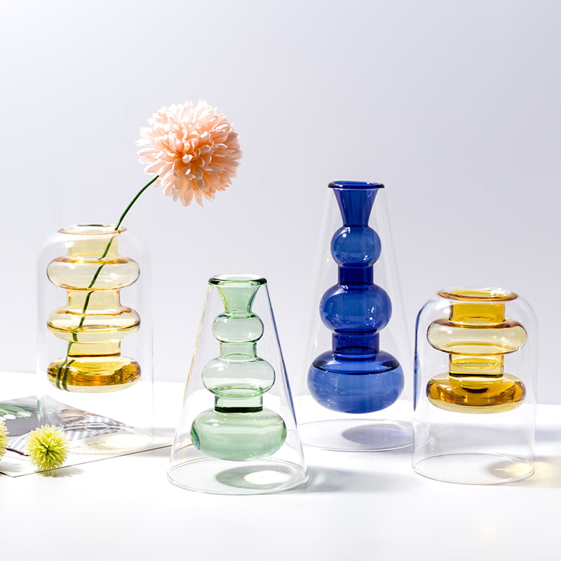 Display for yellowA and yellowB and light green and sapphire blue modern colored glass vase.