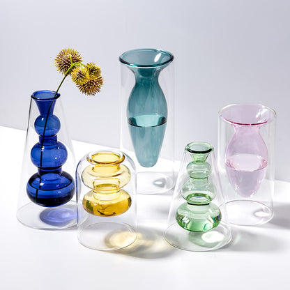 Display for yellowA and light green and light pink and sapphire blue and peacock blue modern colored glass vase.