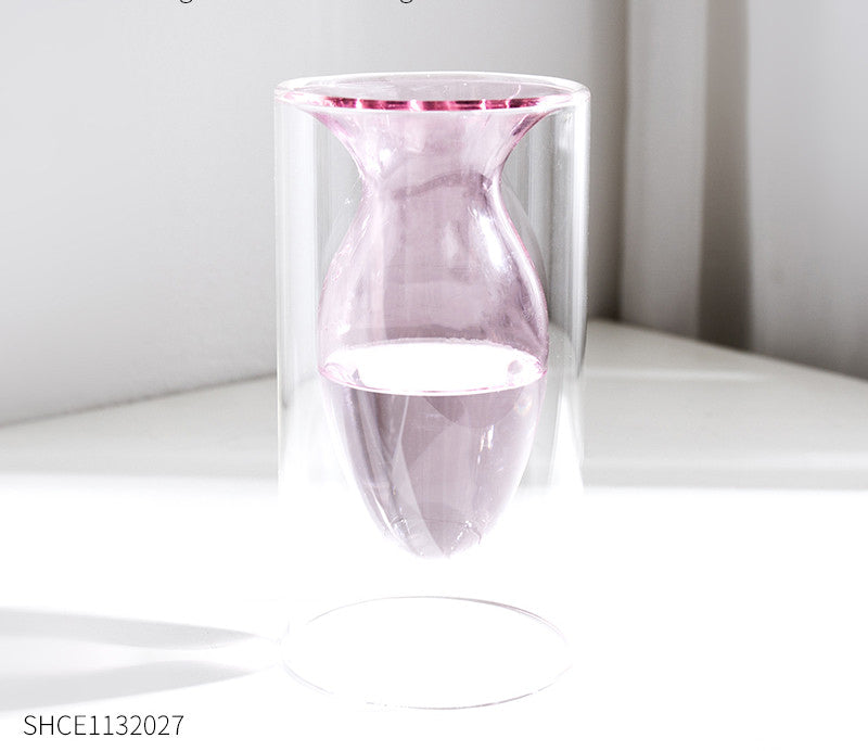 Display for light pink modern colored glass vase.