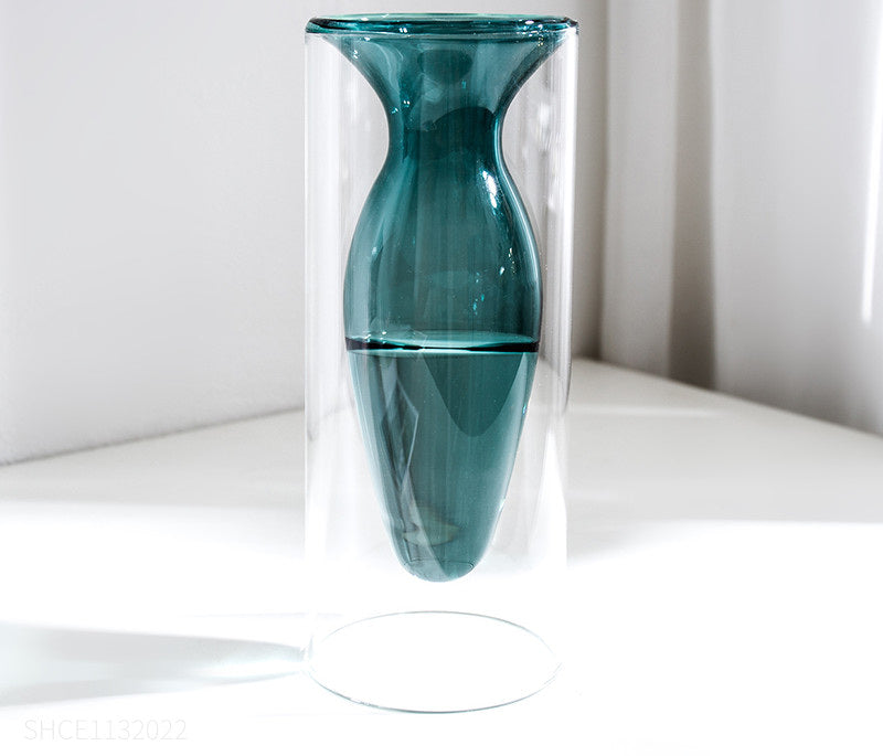 Display for peacock blue modern colored glass vase.