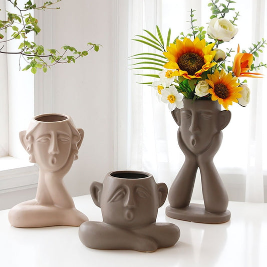 Display for modern face art ceramic vase.