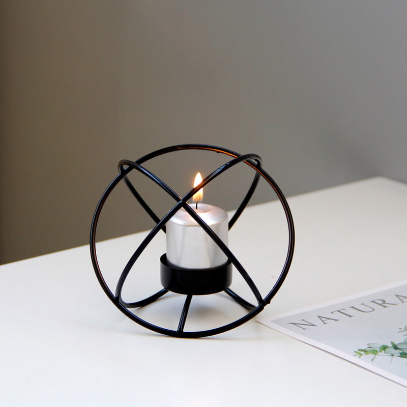 Display for black spherical metal candle holder display.