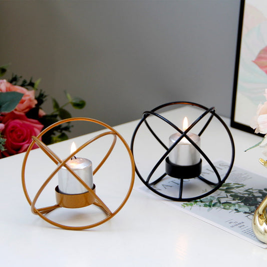 Display for gold and black spherical metal candle holder display.