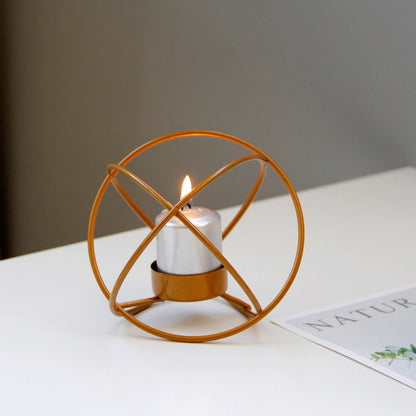 Display for gold spherical metal candle holder display.